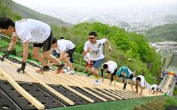 　札幌市の大倉山ジャンプ競技場で、ラージヒルを駆け上がる参加者＝１７日午前