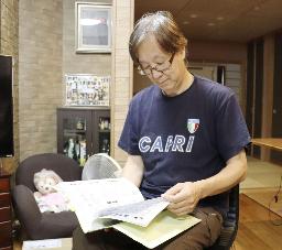 　当時の学級通信を見ながら教え子の思い出を語る猪俣修さん＝２０１８年、埼玉県内