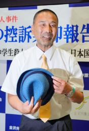 無罪判決後の記者会見を終え、袴田巌さんが使っていた帽子を手に笑顔の前川彰司さん=18日午後、金沢市