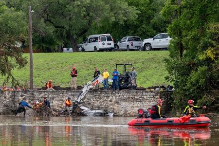 米テキサス州カー郡カービルで、川を捜索する救助関係者=14日(ゲッティ=共同)