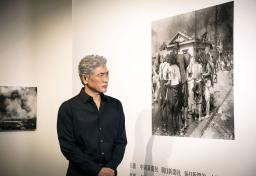 　「被爆８０年企画展　ヒロシマ１９４５」を見学する歌手で俳優の吉川晃司さん＝２日、東京都目黒区の東京都写真美術館