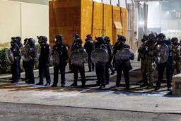 　トランプ大統領の移民政策に抗議するデモの警備に当たるＩＣＥ施設の職員＝９月１日、ポートランド（ロイター＝共同）