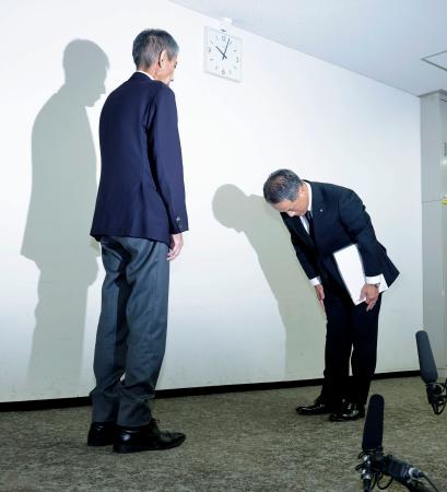 　国際線機長の飲酒問題で、国交省から厳重注意の文書を受け取り謝罪する日航の担当者（右）＝１０日午前、国交省